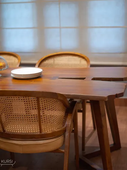 My live-edge teak wood table paired with 'Modis' rattan chairs. Each table is a unique work of nature, bringing warmth and character to your home.