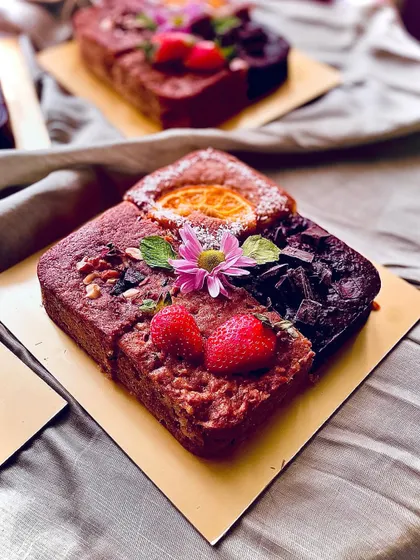 A closer look at the 4-in-1 Valentine's cake, decorated with fresh flowers and fruit. It's a perfect way to sample different flavours.