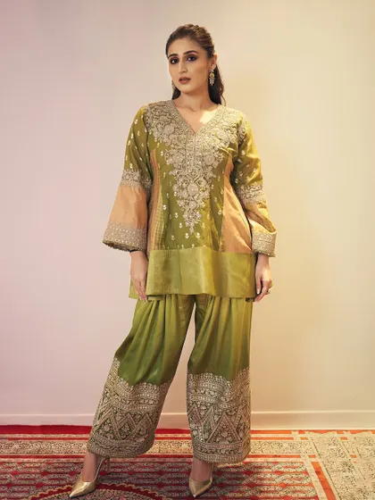 The full view of this elegant peplum sharara by Heena Kochhar. The flared sleeves and intricate embroidery on the pants make it a true statement piece.