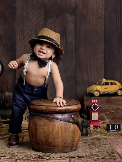 Another angle of the vintage explorer theme, showing the child's happy expression. The combination of the costume and detailed set makes for a very memorable toddler portrait.