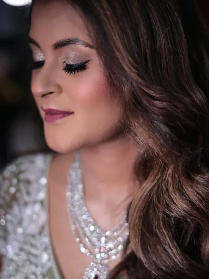 Another angle of the Sangeet look, showing the flawless blend of eyeshadow and the soft curls of her hair.