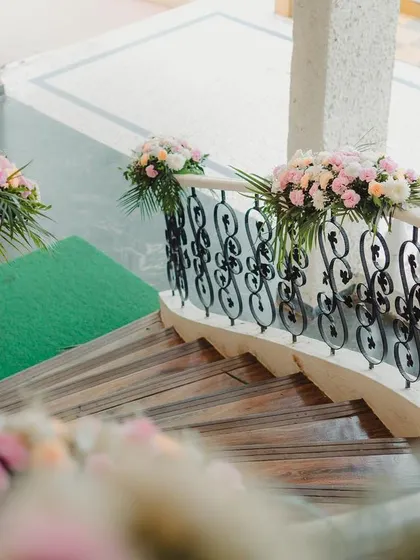 A detail shot of the floral decor on the staircase, welcoming guests to a celebration filled with soothing and dreamy elements.