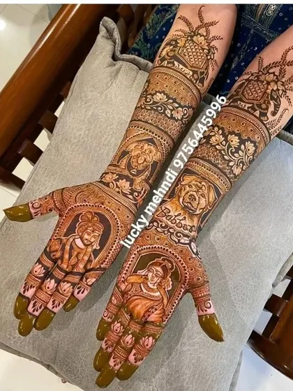 This unique bridal design was for a pet lover. It features portraits of the couple on the palms and their beloved dogs on the forearms, surrounded by floral patterns.