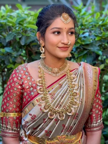 A side profile of the sister of the bride, showing her soft makeup and traditional hairstyle.