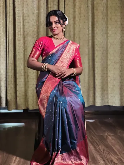 A seated pose can be very elegant in a saree. I ensure the drape looks just as neat and flattering when sitting, with the pleats falling gracefully without bunching up. This is a key consideration for bridal and event draping.