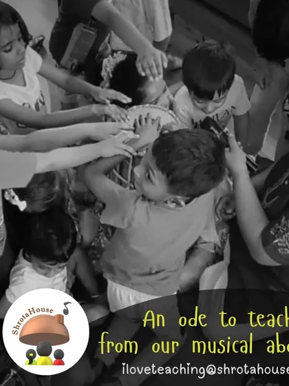 Children gather around a teacher, their hands reaching out to feel the vibrations of the instrument. This physical connection to the music is a core part of the ShrotaHouse experience.