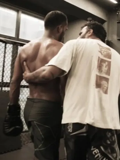 A quiet moment of guidance after a hard round. I am more than a coach shouting from the sidelines. I am in the trenches with my fighters, giving them the support and strategy they need.