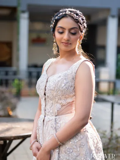 A close-up of the ivory embroidered crop top and organza palazzo set. This view highlights the intricate embroidery on the bodice and the sheer panel at the waist.