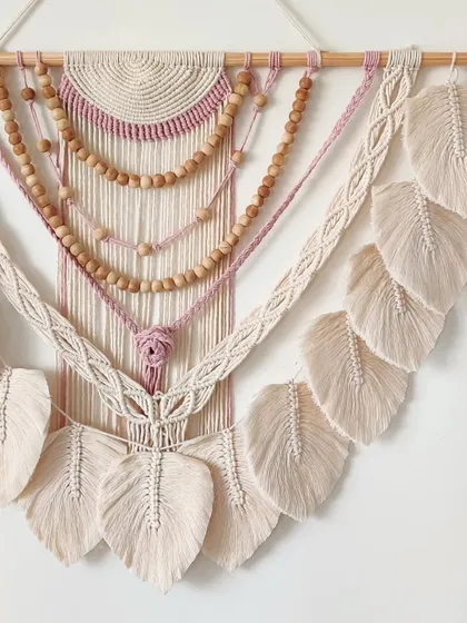 A close-up of the central knot and beaded strands in this lovely wall hanging.