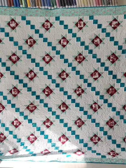 A "Star and Irish Chain" quilt in a beautiful teal and red color combination.