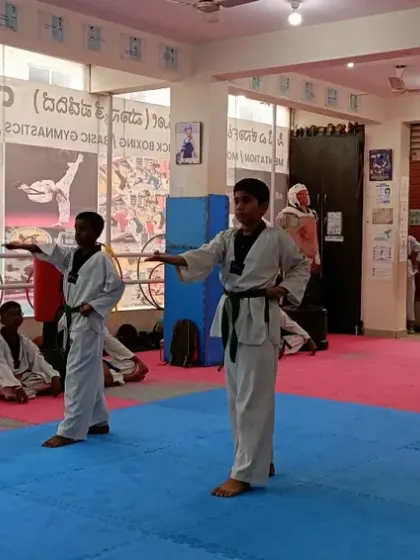 Two black belt students demonstrating a synchronized form.