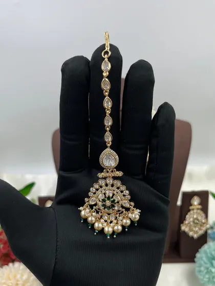 A showcase of our various maang tikkas, designed to match our premium Kundan and Moissanite necklace sets. These accessories complete the bridal look and are a key part of our wholesale sets.