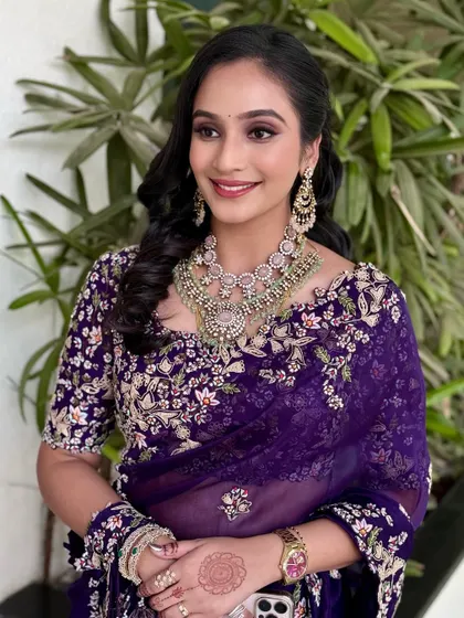 This client is glowing with happiness. The makeup is designed to enhance her natural radiance with a touch of glamour.