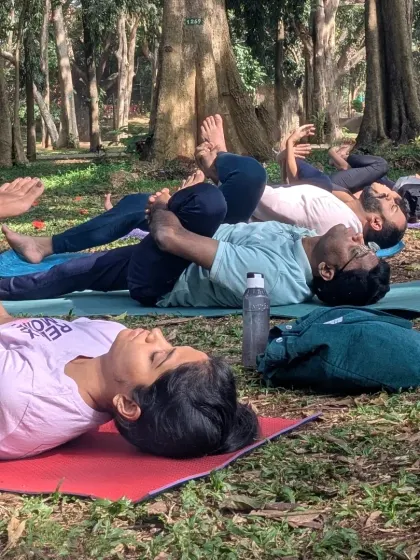 A close-up of students in a reclined hip-opening pose. These moments of quiet stretching are just as important as the dynamic flows, allowing the body to release and recover.