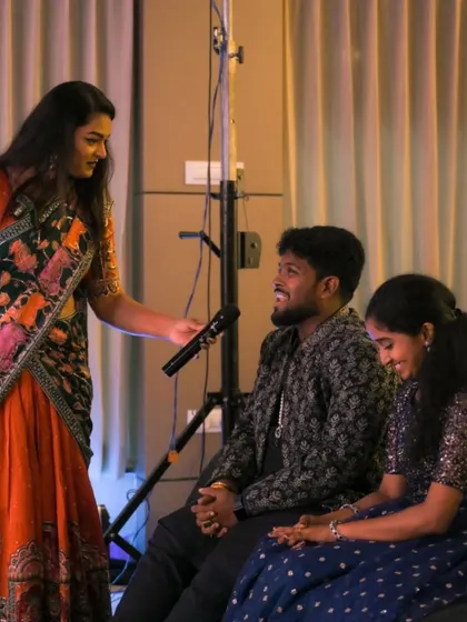 Our anchor engaging with the couple during a fun game. Our hosts are skilled at creating a comfortable and interactive environment on stage.