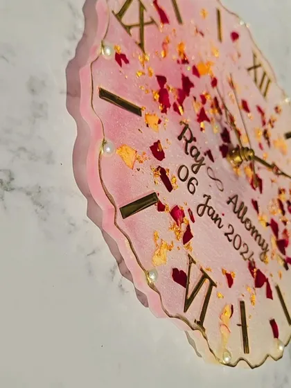 A close-up look at this 10-inch varmala wall clock for Raj and Allomy. The details matter, from the placement of each petal and pearl to the elegant script of their names and wedding date.