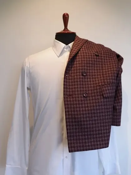 This classic woollen piece features chequered patterns and a double-breasted style, a perfect addition to your formal wardrobe.