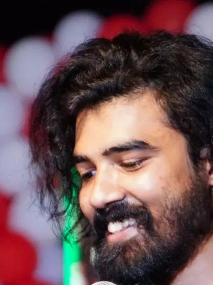 A close-up candid shot capturing a moment of genuine happiness during a performance. I truly love what I do.