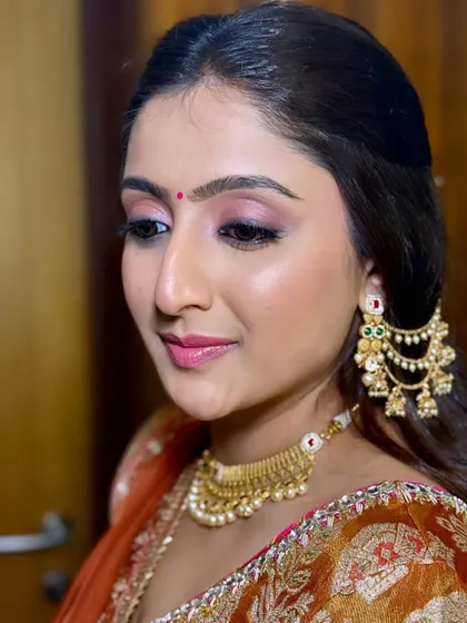 A portrait from a pre-wedding festivity. The soft pink and gold tones on her eyes complement her traditional outfit and gold jewelry perfectly.