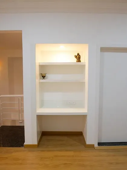 A simple yet elegant built-in shelving unit in Richa and Abhay's home, providing a perfect spot for displaying decor and personal items.