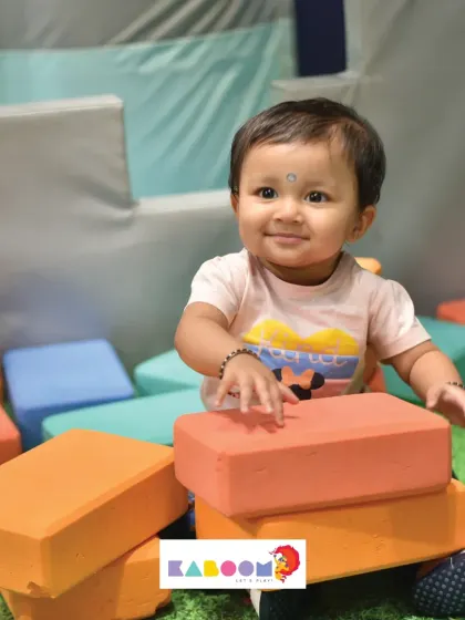 This adorable little builder is having a quiet moment with our soft play blocks. We offer activities for all energy levels.