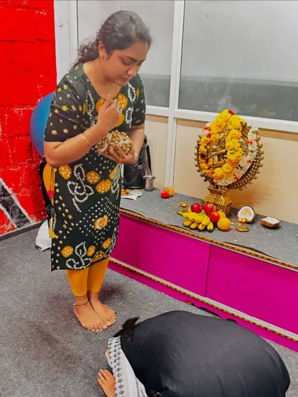 A student seeking blessings from her guru during the Gejje Pooja ceremony.
