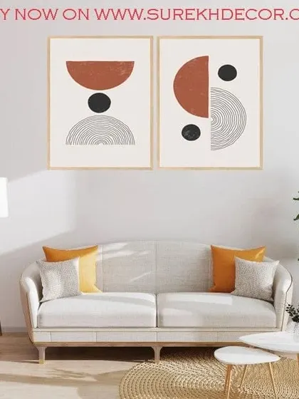 This set of two framed art prints features bowed, abstract shapes in a warm, earthy palette. The combination of solid colors and line work creates a balanced and modern composition.