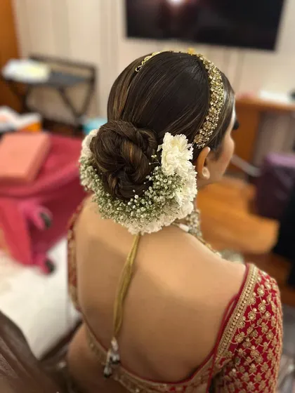 Another angle of the classic bridal gajra bun. You can see how the highlights in the hair add dimension to the twists of the bun.