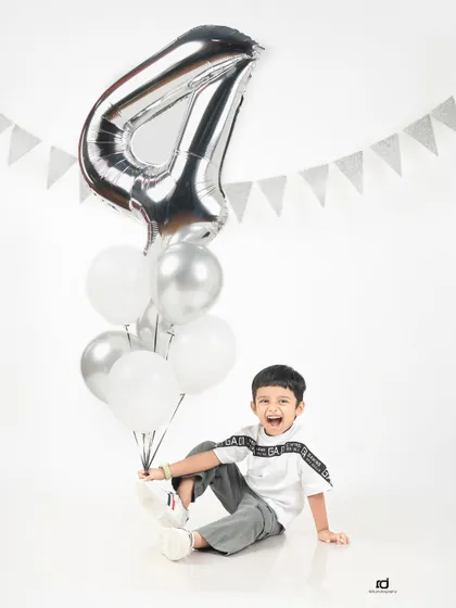 Look at that big, joyful smile. This little boy is so excited to be celebrating his fourth birthday in the studio.