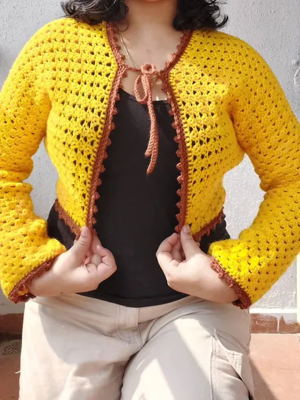 This is the Odette Cardigan, a beautiful piece made with a classic granny stitch pattern and finished with a contrasting border.