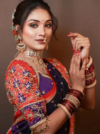 A traditional Maharashtrian look created for a photoshoot. The vibrant Paithani saree is paired with classic makeup, including a chandrakor bindi and a nath.