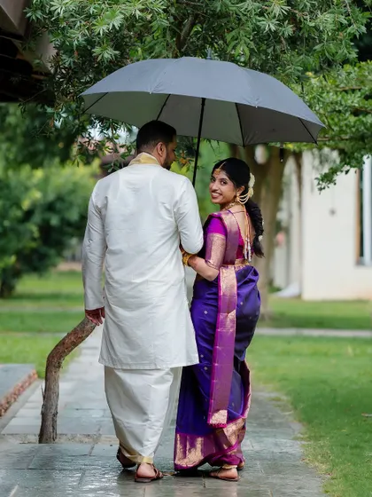 A romantic stroll in the rain. We embrace every element of the wedding day, even a little monsoon magic, to create unique and memorable couple portraits.