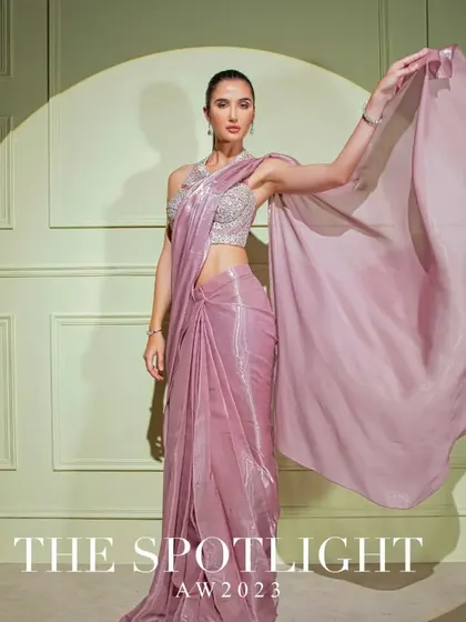 A campaign shot of a mauve metallic drape saree, capturing its beautiful flow and shimmering texture.