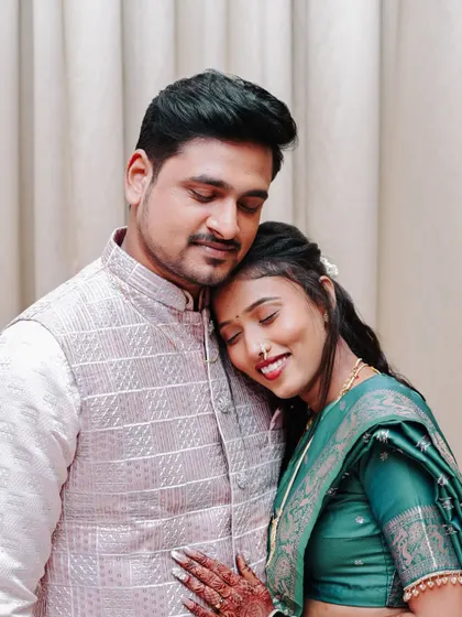 An intimate and serene moment, with the bride resting her head on the groom's shoulder.