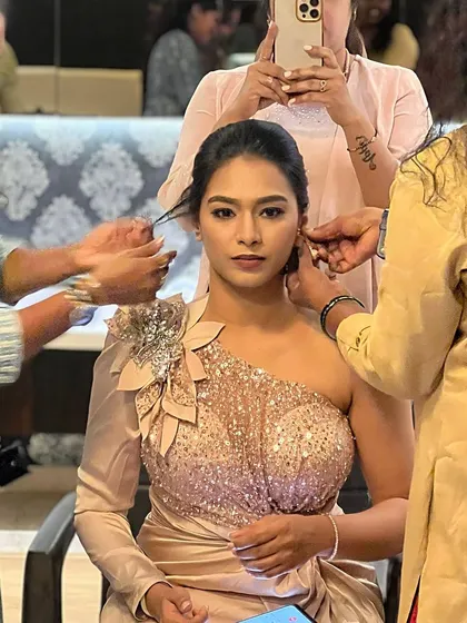This behind-the-scenes shot shows a team working on a modern, glamorous look. My training prepares you for the fast-paced environment of real weddings and events.