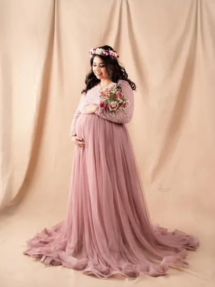 Adding a floral crown and a small bouquet can bring a lovely, bohemian feel to a gown session. This mom-to-be looks beautiful in her pink lace dress.