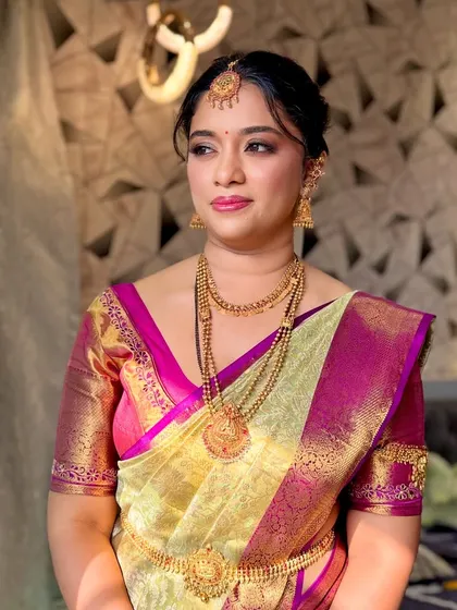 A three-quarter profile of the bride, looking regal and poised in her traditional attire.