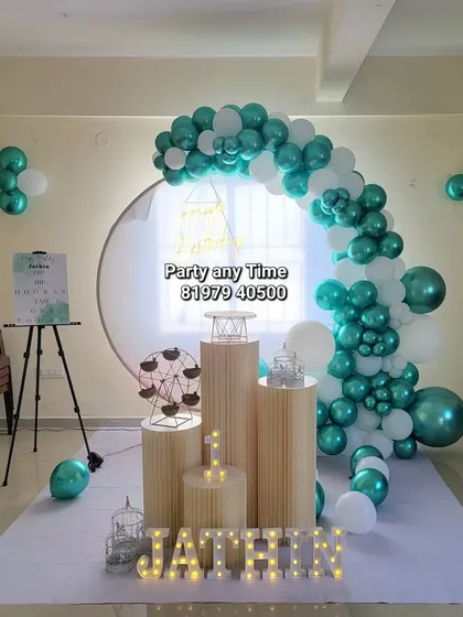 A wide shot of the elegant first birthday setup in a party hall.