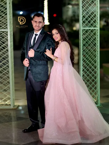 A classic couple portrait from an engagement party. The bride in her pink gown and the groom in his sharp green velvet suit make a stylish pair.