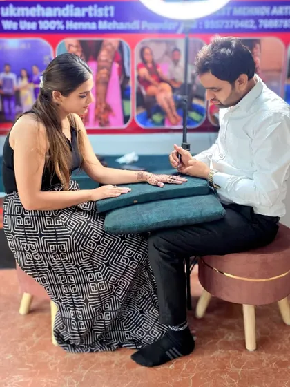 A student receiving one-on-one guidance during a mehandi session. I make sure every student gets personal attention to perfect their technique.