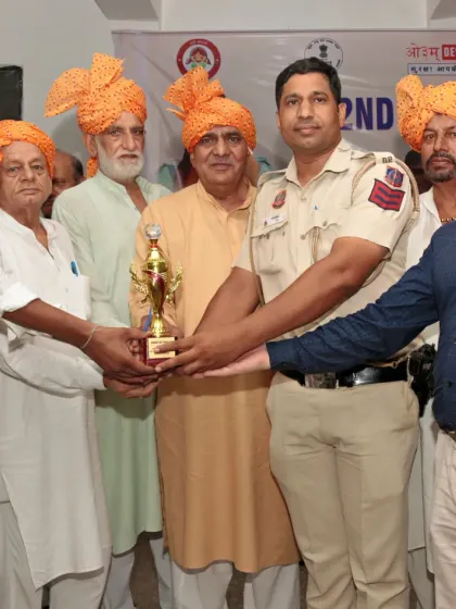 A moment of pride as a student receives his championship trophy from a respected guest.