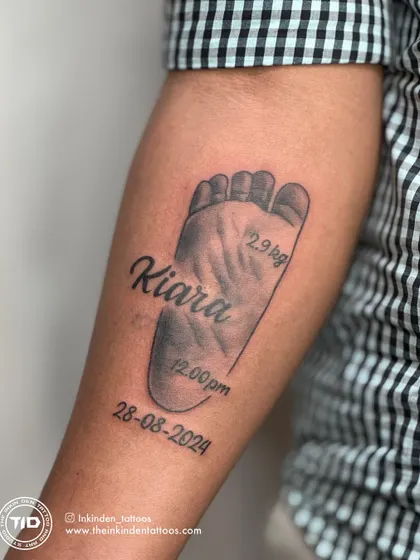 I specialize in immortalizing your most precious memories. This tattoo captures the exact footprint of a client's newborn, complete with their name, birth date, and weight, creating a timeless tribute to a new life.