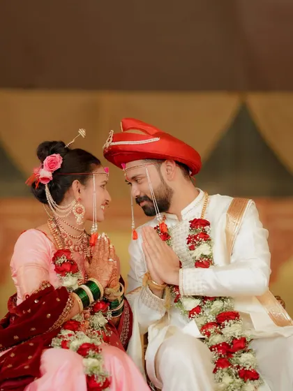 A moment of quiet reverence during the wedding ceremony. The couple's joined hands and shared glance create a powerful, emotional image.