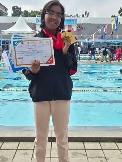 Prachita Deb with her three gold medals and certificates from the UTPULTA Non-Medalist Competition, a phenomenal performance in freestyle and butterfly events.