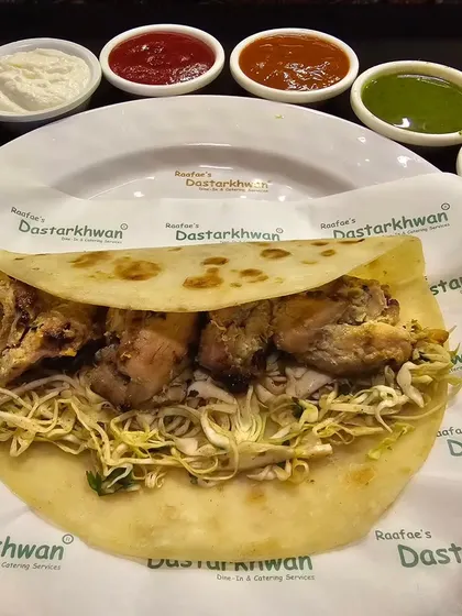 This is my Chicken Tikka Roll. Smoky, tandoor-grilled chicken tikka pieces are wrapped in a paratha with fresh salad, offering a classic taste that everyone loves.