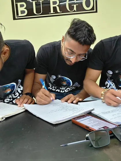 A close-up of students taking detailed notes. My workshops are packed with actionable information, and I encourage everyone to document the processes and tips we discuss.