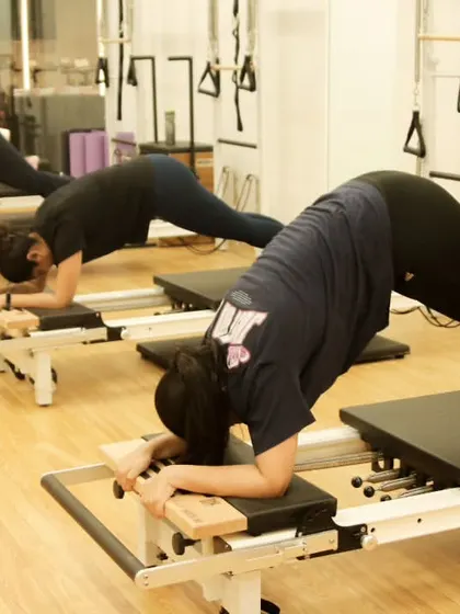 Another angle of the reformer plank, showing the focus and determination of the class as they work together to build core endurance.