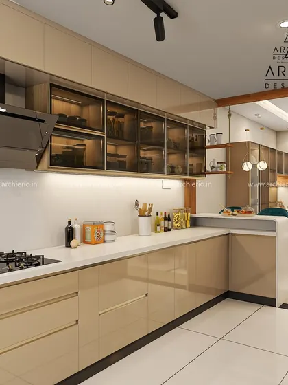 This L-shaped kitchen combines glossy beige cabinets with glass-front upper units and a clean white countertop, creating a bright and open feel.