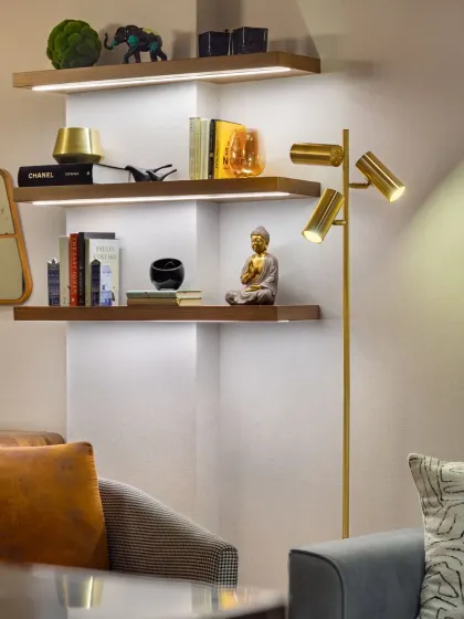 Details breathe life into a home. At Rue 32, floating bookshelves with integrated lighting create a moment of airy grace, showcasing personal objects and adding a soft, warm glow to the living area.