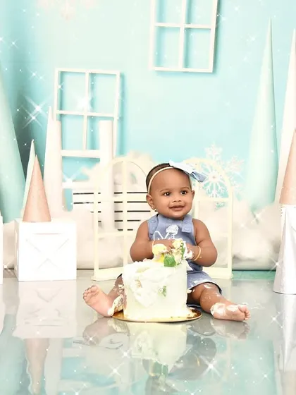 A sweet cake smash moment from a winter wonderland themed shoot. The simple joy of digging into a cake is a memory every parent treasures.